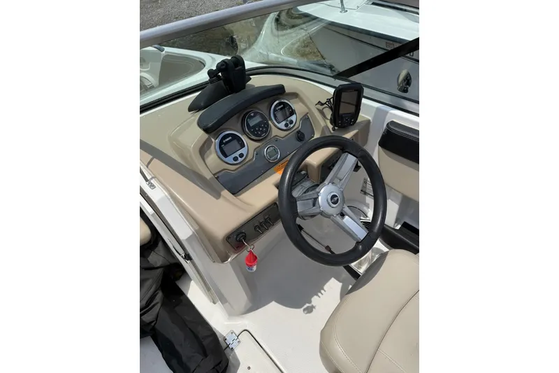 Slide: The Image of 2018 Chaparral 21 H2O Ski & Fish OB dashboard with steering wheel and gauges. - 9