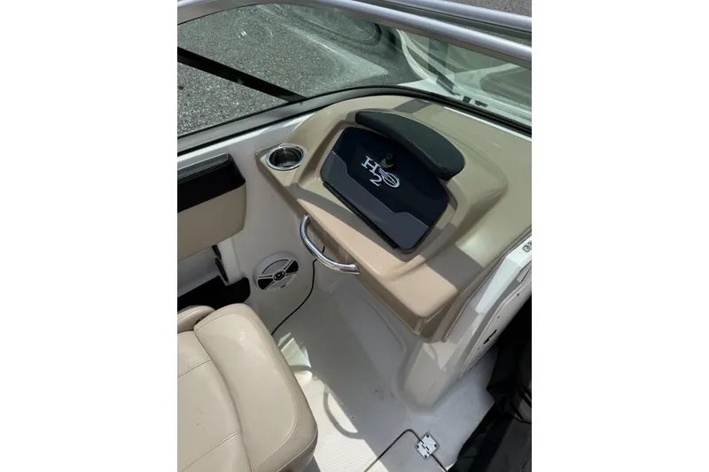 Slide: The Image of 2018 Chaparral 21 H2O Ski & Fish OB boat interior with beige seating and dashboard. - 8