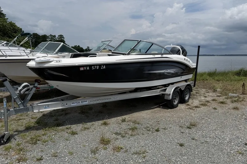 The Image of 2018 Chaparral 21 H2O Ski & Fish OB boat on trailer by lakeside. - 1