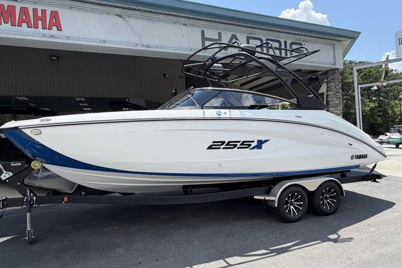 The Image of 2026 Yamaha Boats 255XE on trailer outside dealership, showcasing sleek design and modern features. - 1