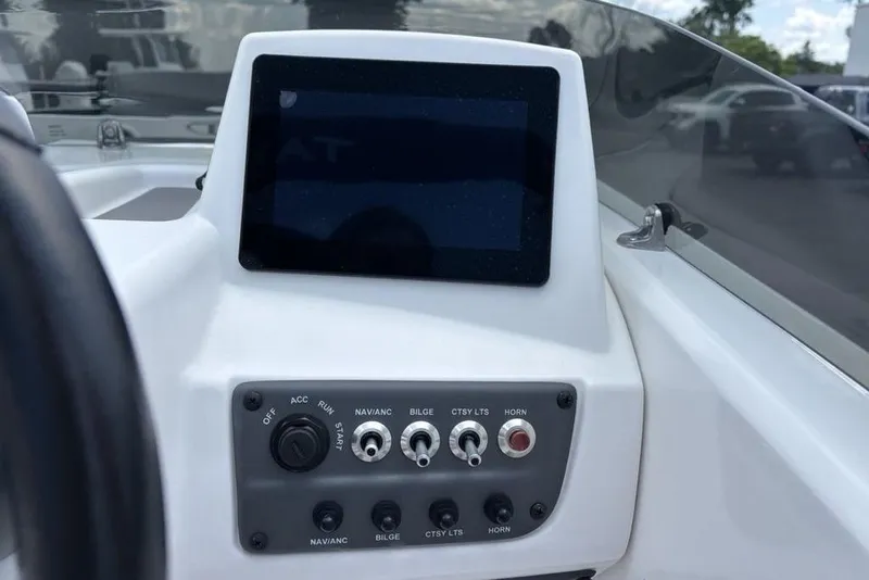 Slide: The Image of 2024 Tahoe T18 boat dashboard with control panel and display screen. - 15