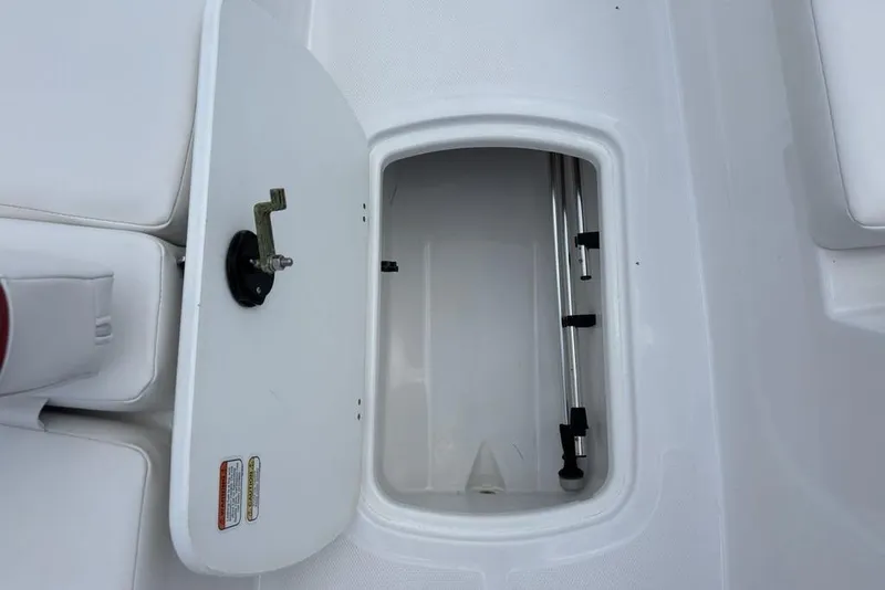 Slide: The Image of Open storage compartment in 2024 Tahoe T18 boat, featuring a sleek white interior design. - 14