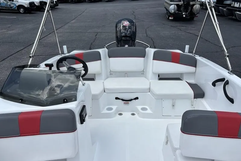 Slide: The Image of 2024 Tahoe T18 boat interior with red and gray seating, steering wheel, and windshield. - 16