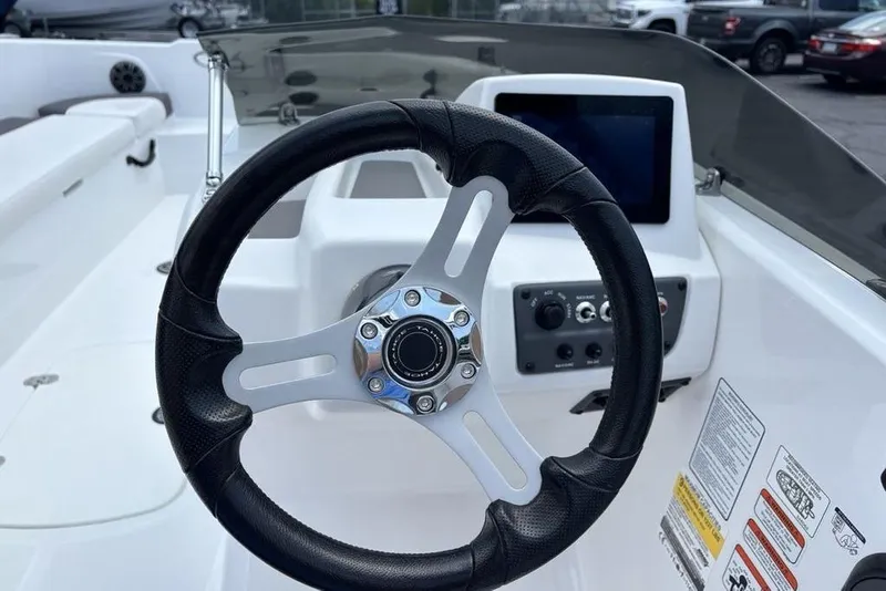 Slide: The Image of Steering wheel and dashboard of 2024 Tahoe T18 boat, featuring modern controls and design. - 20