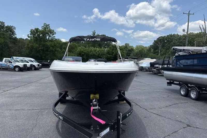 Slide: The Image of 2024 Tahoe T18 boat on trailer in outdoor dealership lot. - 3