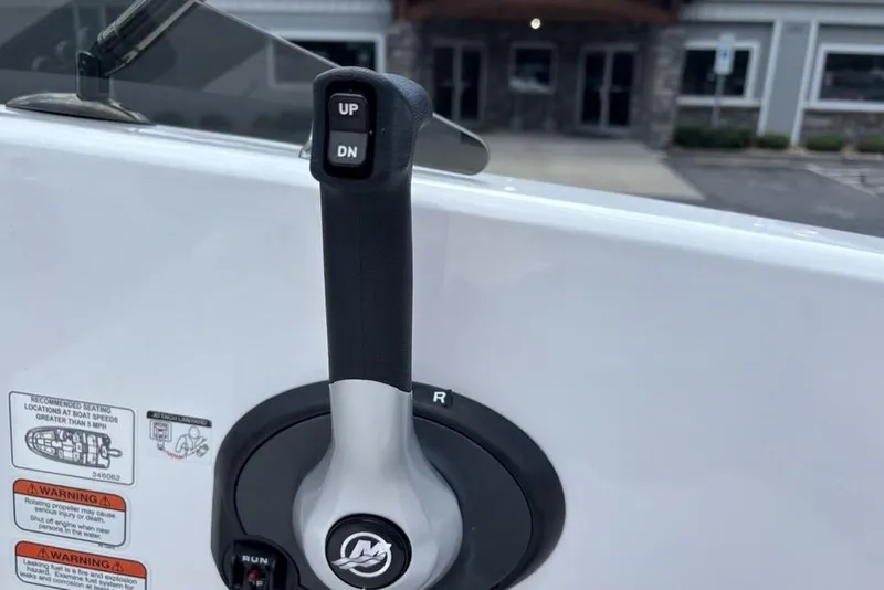 Slide: The Image of Throttle control lever on a 2024 Tahoe T18 boat, featuring up and down buttons. - 12