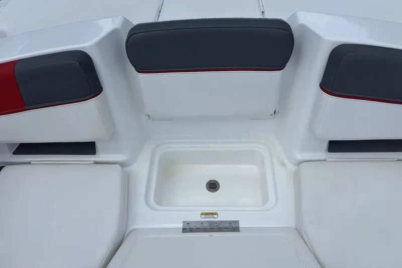 Slide: The Image of 2024 Tahoe T18 boat seating area with storage compartment and drain. - 23