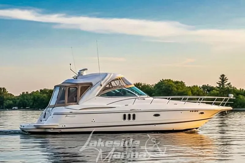 The Image of 2006 Cruisers Yachts 420 Express on serene lake at sunset. - 0