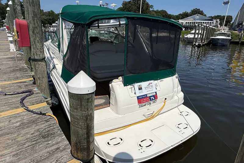 Slide: The Image of 2001 Sea Ray 340 Sundancer docked, green canopy, for sale sign visible. - 3