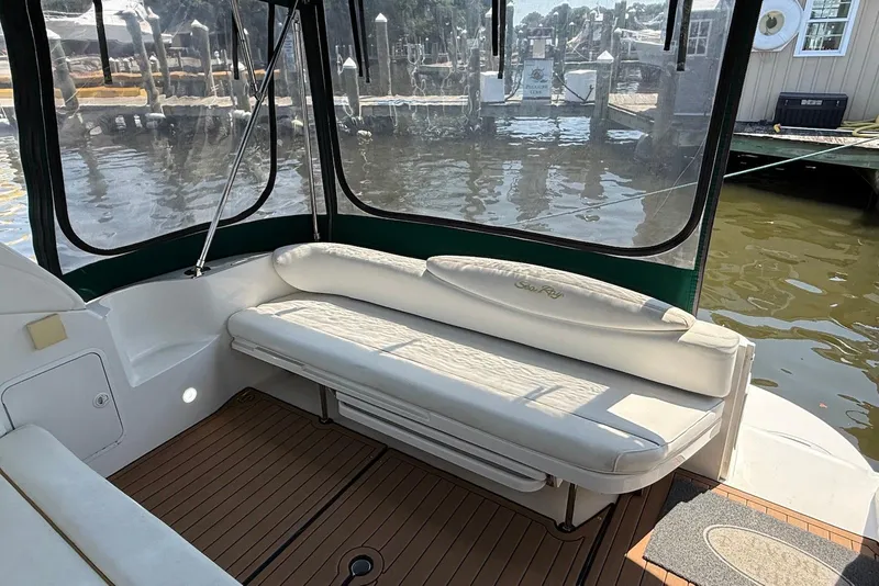 Slide: The Image of 2001 Sea Ray 340 Sundancer boat interior with white seating and wood flooring. - 6