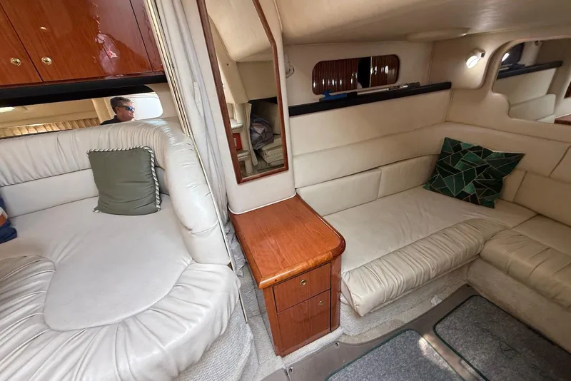 Slide: The Image of Interior of 2001 Sea Ray 340 Sundancer with cream leather seating and wooden cabinetry. - 15