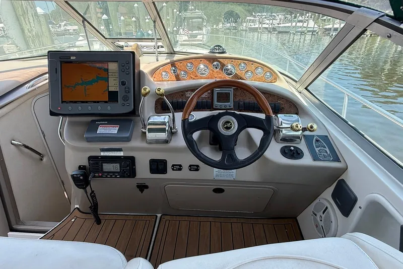 Slide: The Image of Cockpit of 2001 Sea Ray 340 Sundancer with navigation system and wooden steering wheel. - 9