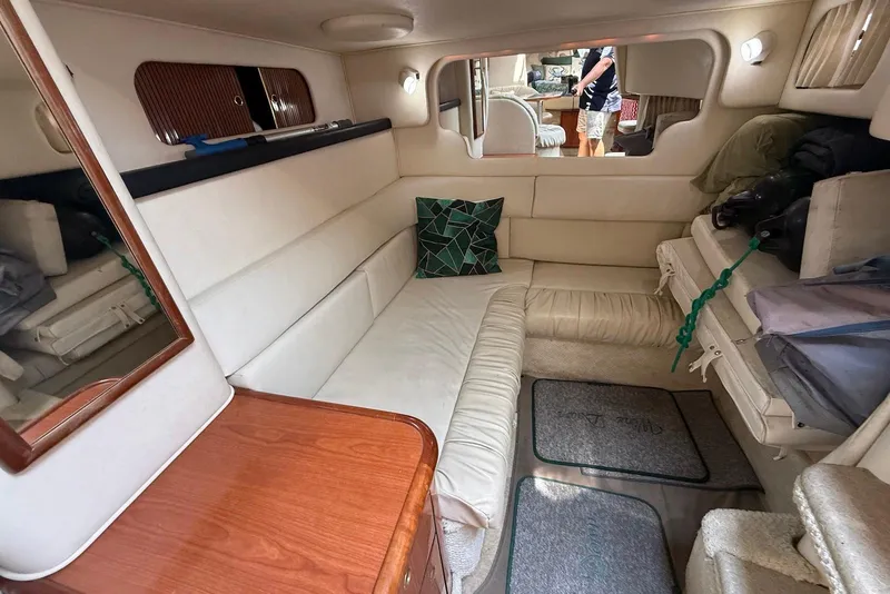 Slide: The Image of Interior of 2001 Sea Ray 340 Sundancer yacht with cozy seating and wooden accents. - 16