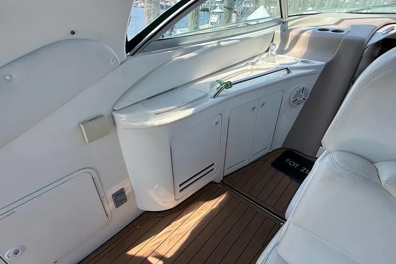 Slide: The Image of Interior of 2001 Sea Ray 340 Sundancer yacht with sleek cabinetry and wood flooring. - 7