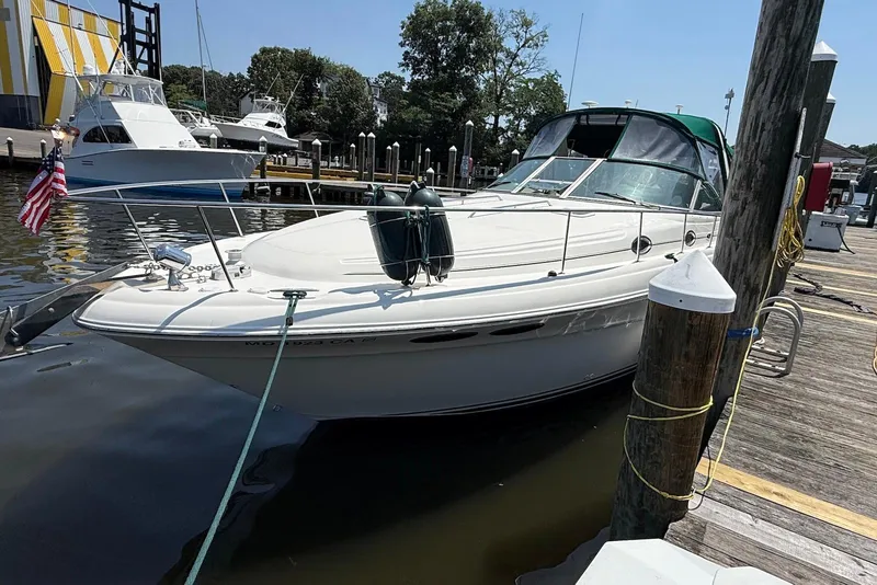 Slide: The Image of 2001 Sea Ray 340 Sundancer docked at marina, sunny day, American flag displayed. - 2