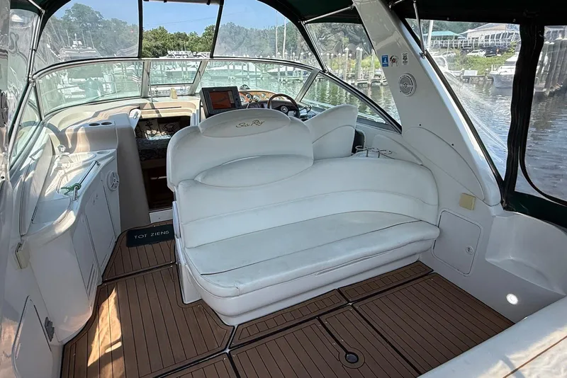 Slide: The Image of 2001 Sea Ray 340 Sundancer boat interior with white seating and wooden flooring. - 5