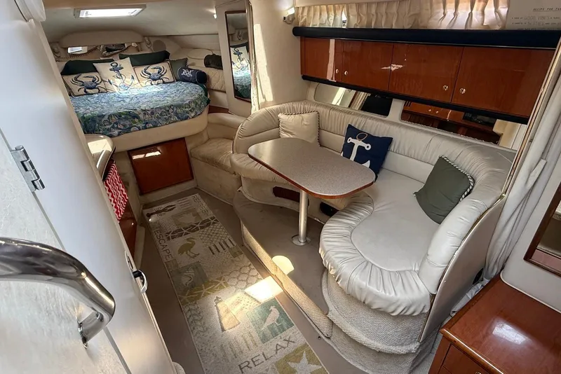Slide: The Image of Interior of 2001 Sea Ray 340 Sundancer yacht with cozy seating and nautical decor. - 13