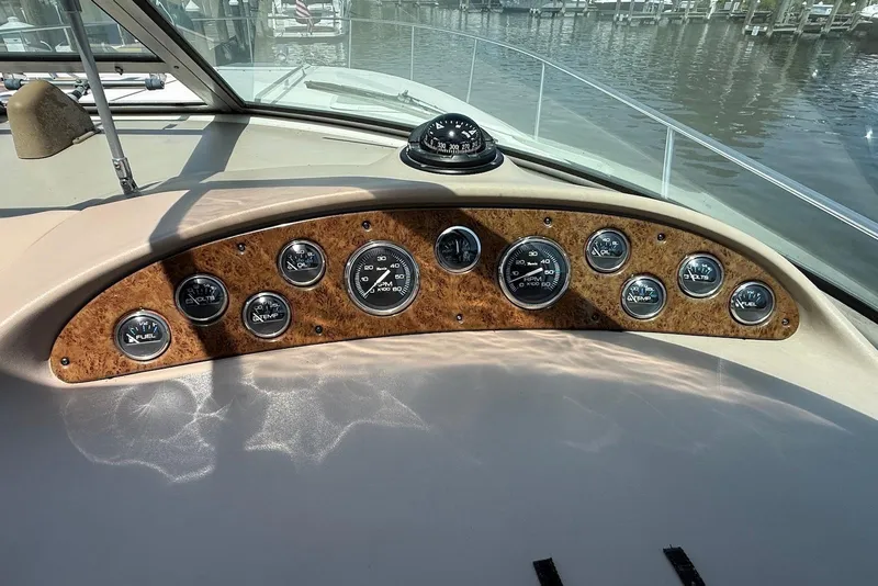 Slide: The Image of Dashboard of a 2001 Sea Ray 340 Sundancer boat with gauges and compass. - 11