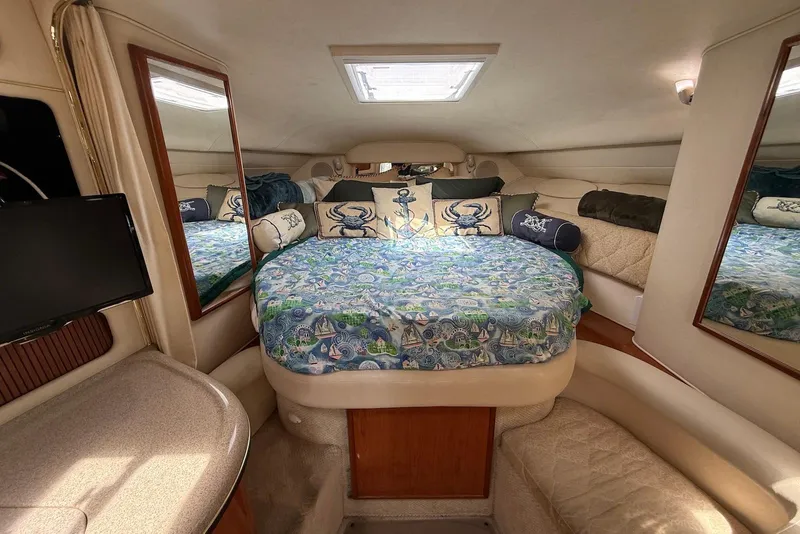 Slide: The Image of Interior cabin of 2001 Sea Ray 340 Sundancer with nautical-themed bedding and mirrors. - 18