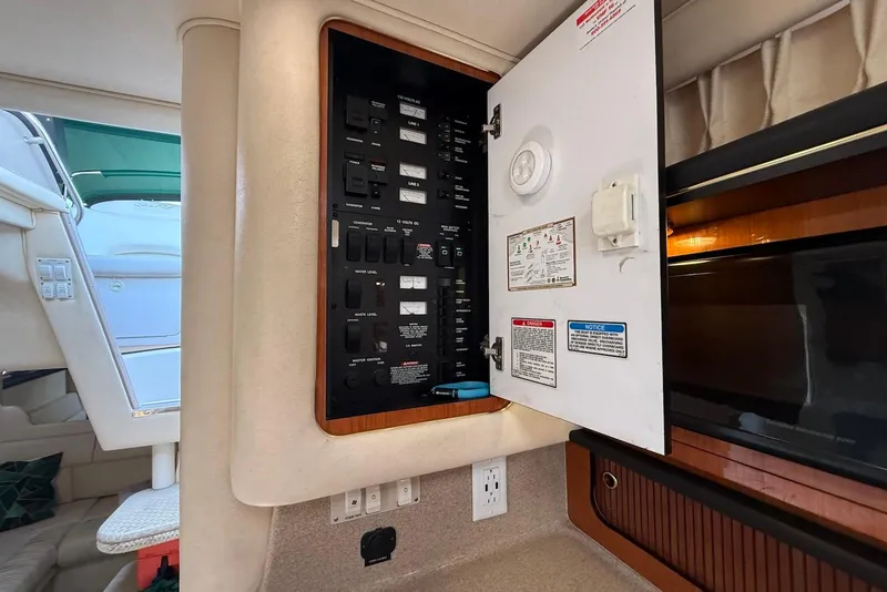 Slide: The Image of Electrical panel inside 2001 Sea Ray 340 Sundancer yacht, showcasing switches and controls. - 19