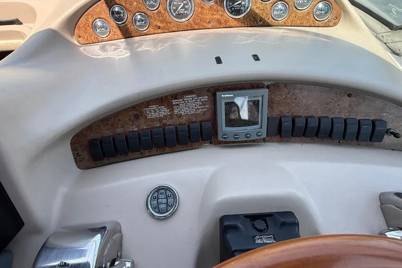 Slide: The Image of Dashboard of a 2001 Sea Ray 340 Sundancer boat with gauges and controls. - 12