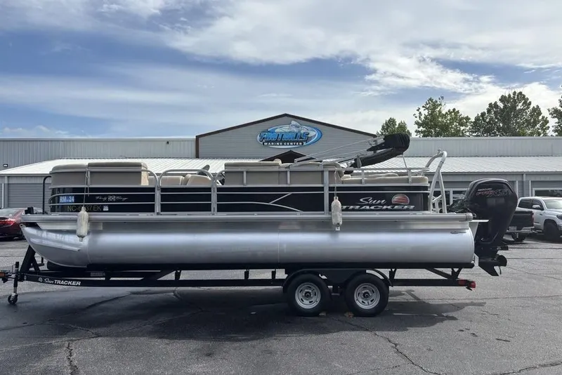 Slide: The Image of 2019 Sun Tracker Party Barge 22 RF DLX pontoon boat on trailer, parked outdoors. - 30