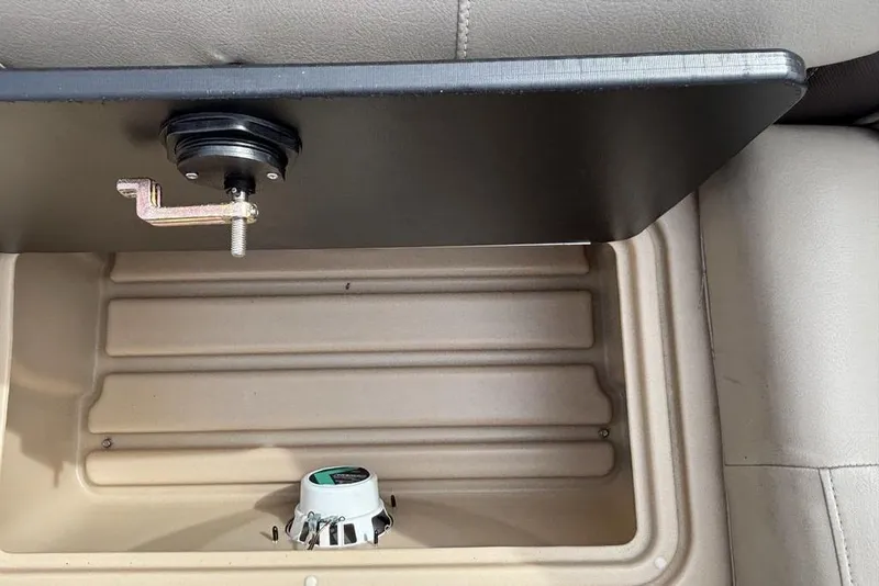 Slide: The Image of 2019 Sun Tracker Party Barge 22 RF DLX storage compartment with speaker and latch mechanism. - 23