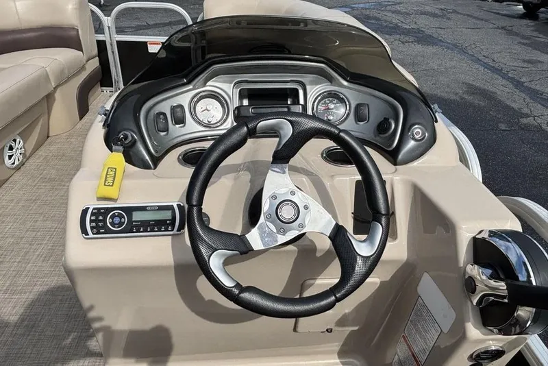 Slide: The Image of 2019 Sun Tracker Party Barge 22 RF DLX steering console with controls and gauges. - 15