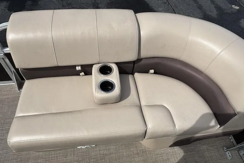 Slide: The Image of 2019 Sun Tracker Party Barge 22 RF DLX beige seating with cup holders. - 10