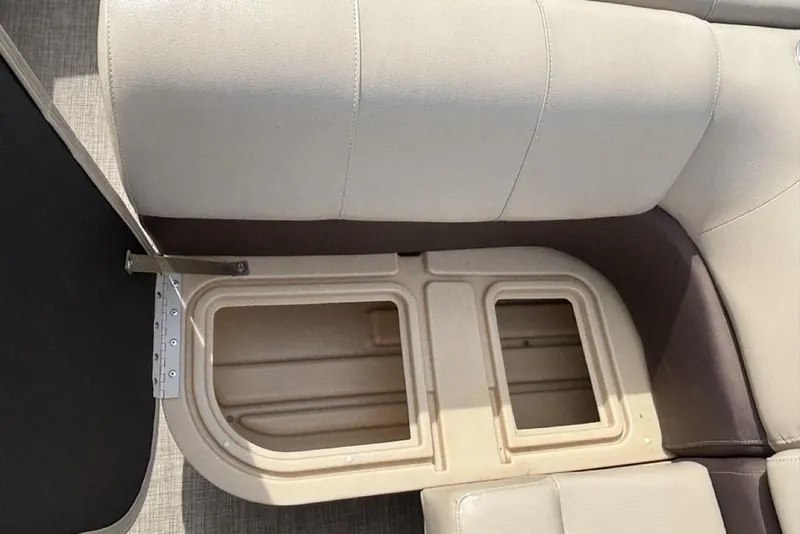 Slide: The Image of 2019 Sun Tracker Party Barge 22 RF DLX storage compartment with beige seating. - 13