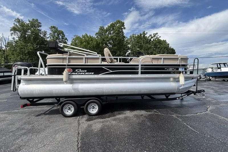 The Image of 2019 Sun Tracker Party Barge 22 RF DLX pontoon boat on trailer, parked outdoors. - 1