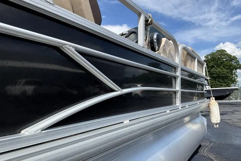 Slide: The Image of 2019 Sun Tracker Party Barge 22 RF DLX pontoon boat, black exterior, docked outdoors. - 7