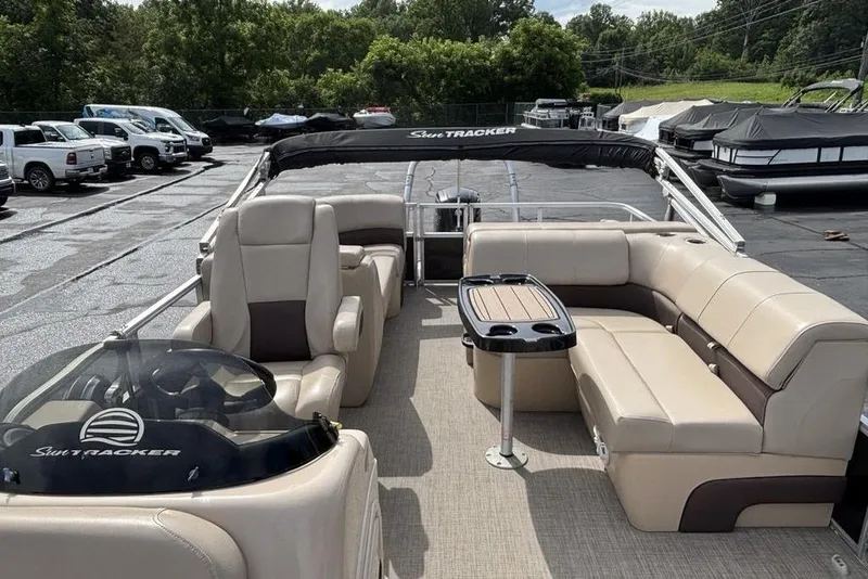 Slide: The Image of 2019 Sun Tracker Party Barge 22 RF DLX pontoon boat with beige seating and table. - 14