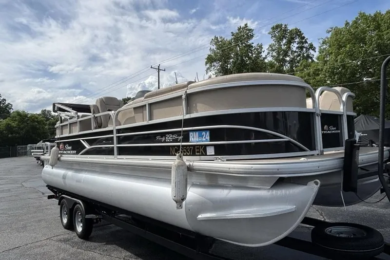 Slide: The Image of 2019 Sun Tracker Party Barge 22 RF DLX pontoon boat on trailer, parked outdoors. - 4