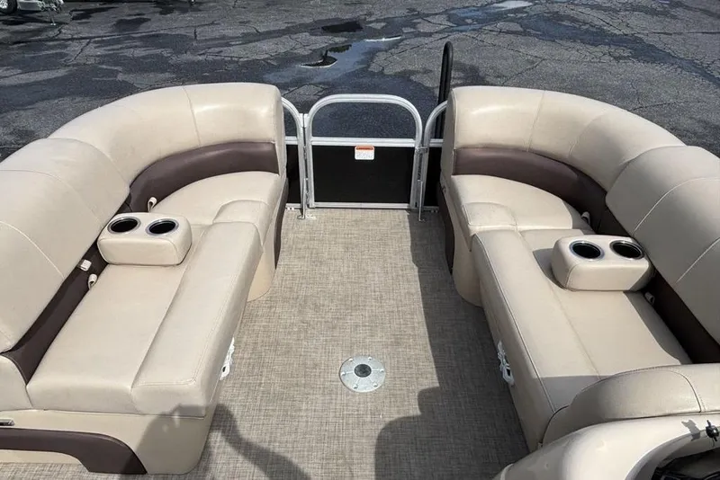 Slide: The Image of 2019 Sun Tracker Party Barge 22 RF DLX interior with beige seating and cup holders. - 5