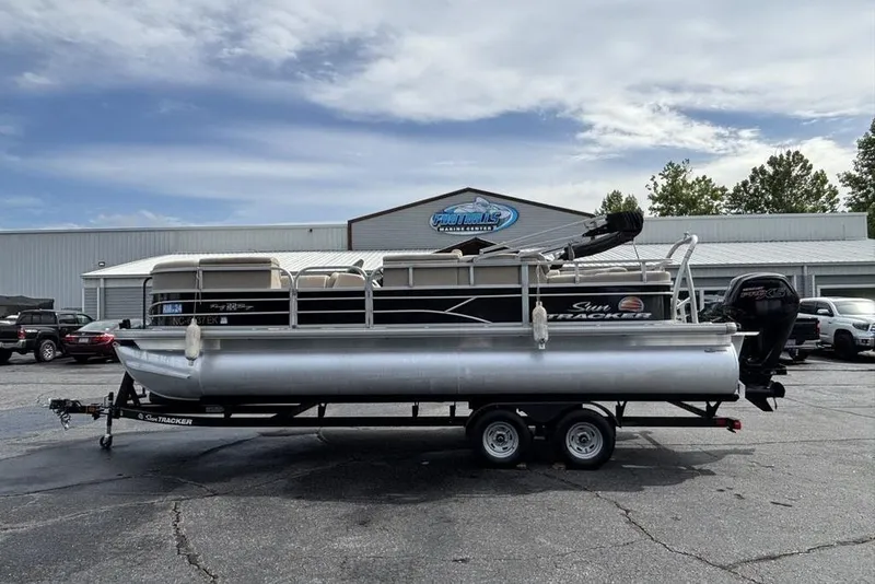Slide: The Image of 2019 Sun Tracker Party Barge 22 RF DLX pontoon boat on trailer, parked outdoors. - 31