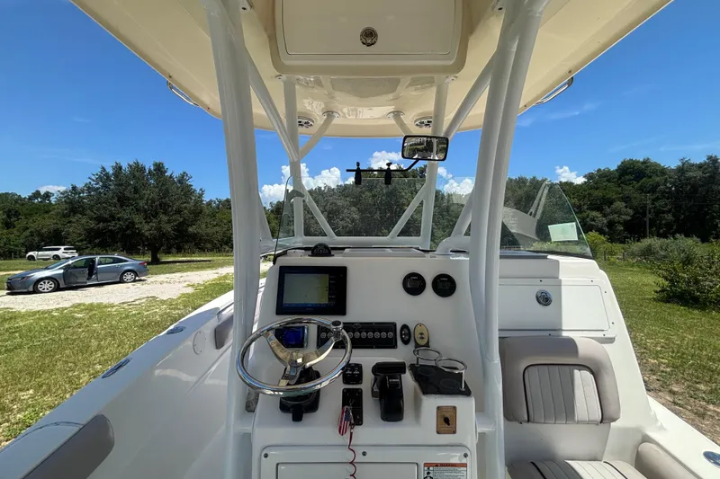 Slide: The Image of 2016 Sea Fox 249 Avenger boat cockpit with steering wheel and navigation controls. - 20