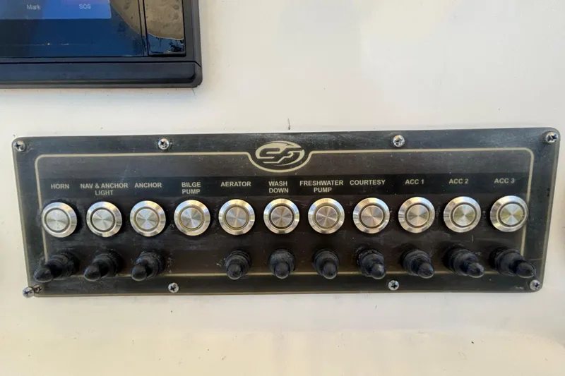Slide: The Image of Control panel of a 2016 Sea Fox 249 Avenger boat with labeled switches. - 26
