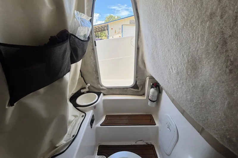 Slide: The Image of Interior view of 2016 Sea Fox 249 Avenger boat cabin with seating and storage. - 47