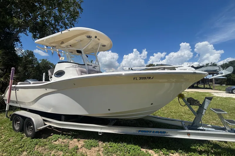 The Image of 2016 Sea Fox 249 Avenger boat on trailer under clear blue sky. - 0