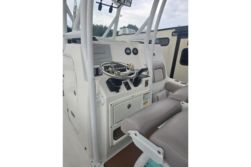 Slide: The Image of 2016 Sea Fox 249 Avenger boat cockpit with Garmin navigation system and comfortable seating. - 5