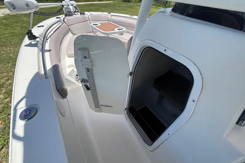 Slide: The Image of 2016 Sea Fox 249 Avenger boat interior with open storage compartment and seating area. - 41