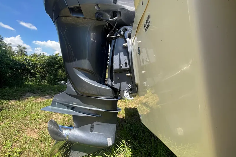 Slide: The Image of 2016 Sea Fox 249 Avenger boat motor close-up, outdoors on grass. - 3