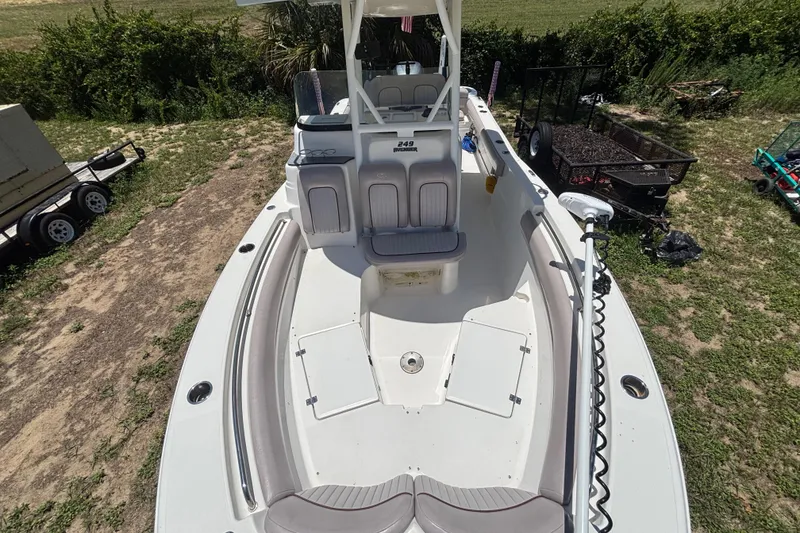 Slide: The Image of 2016 Sea Fox 249 Avenger boat on grassy terrain, showcasing spacious deck and seating. - 65