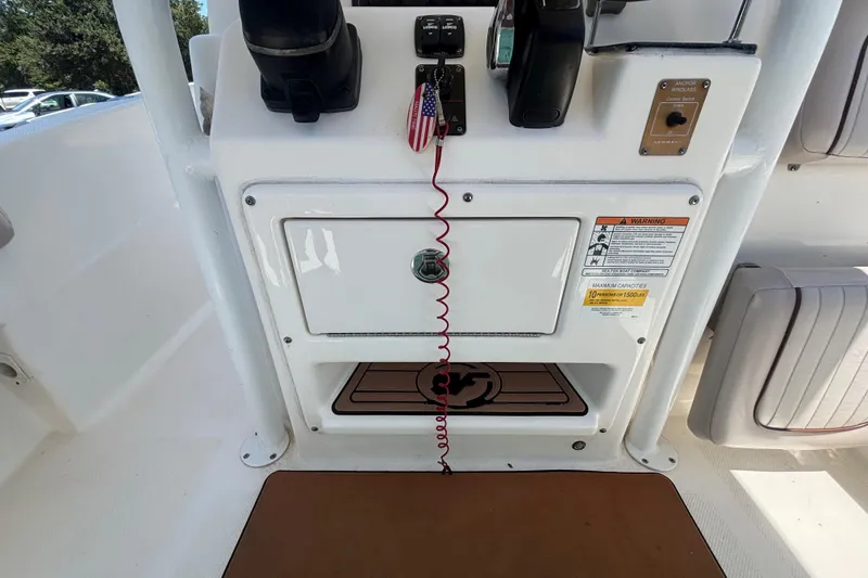 Slide: The Image of 2016 Sea Fox 249 Avenger boat console with controls, storage, and safety warnings. - 27