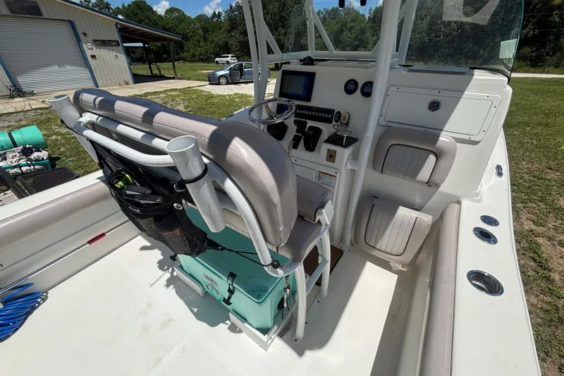 Slide: The Image of 2016 Sea Fox 249 Avenger boat interior with helm, seating, and storage compartments. - 34