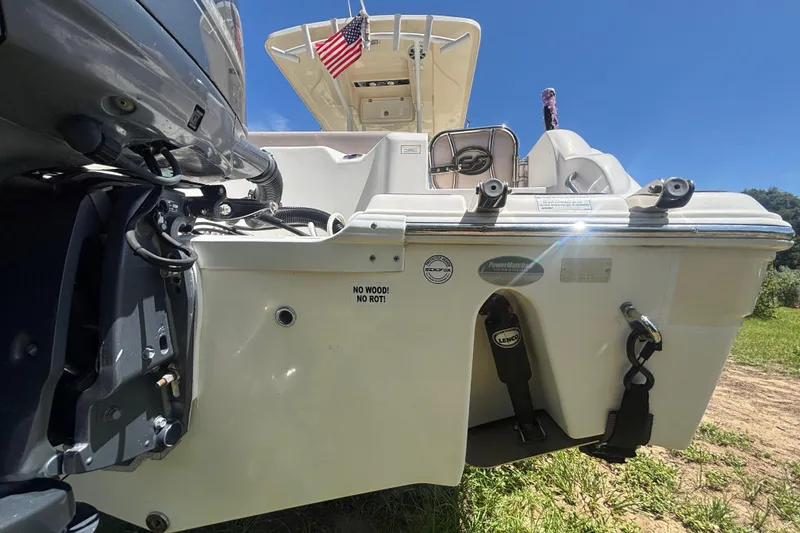 Slide: The Image of 2016 Sea Fox 249 Avenger boat rear view with motor and American flag. - 4