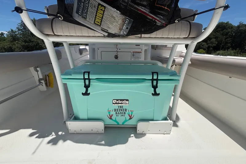 Slide: The Image of 2016 Sea Fox 249 Avenger boat interior with teal Grizzly cooler and fishing gear. - 17