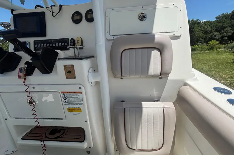 Slide: The Image of Interior view of a 2016 Sea Fox 249 Avenger boat, featuring dashboard and seating. - 35