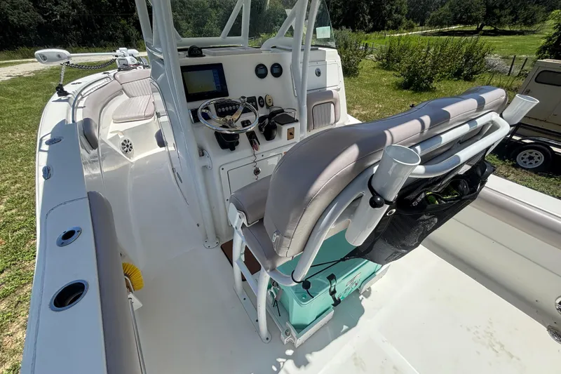 Slide: The Image of 2016 Sea Fox 249 Avenger boat interior with helm, seating, and fishing rod holders. - 38
